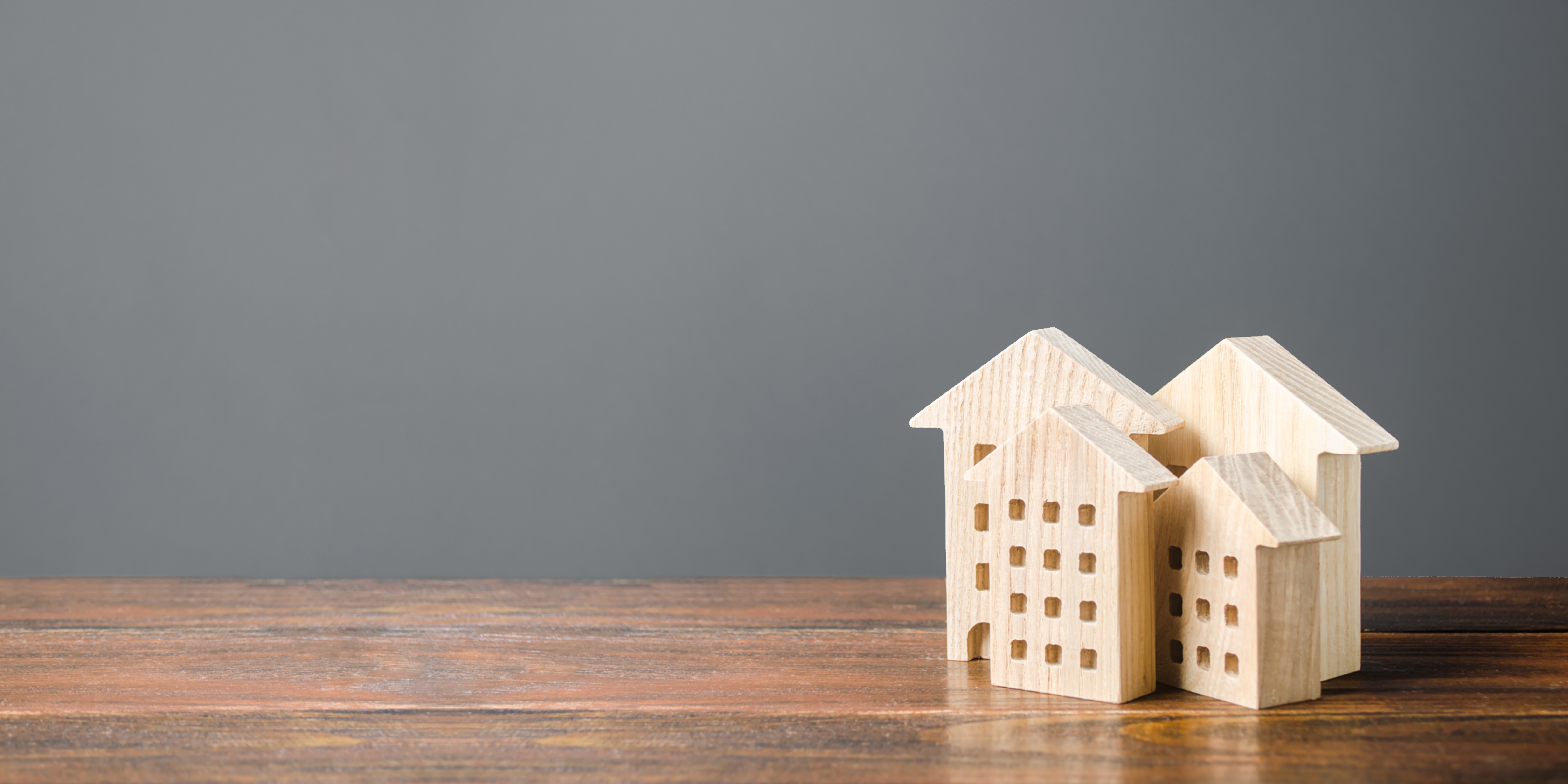 Image of a group of wood blocks shaped like houses and condominiums.